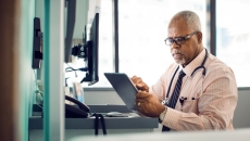 Doctor using EHR tablet