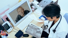 A doctor speaking to a senior on videochat