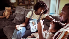 A family consults with a doctor via tablet