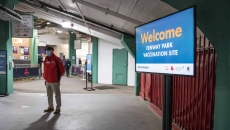 A sign in a corridor saying: Welcome. Fenway Park vaccination site