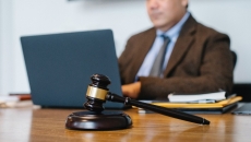 A gavel in front of a computer