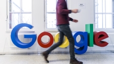 Google sign with worker walking by