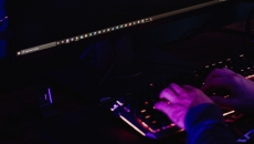 A pair of hands on a darkened keyboard