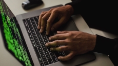A hacker's hands on a keyboard