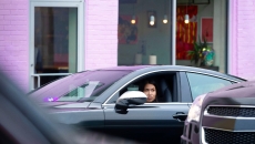 A driver sits in a Lyft