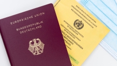 A photo of the WHO yellow card and European Union passport