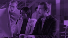 Workers looking at a monitor