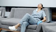 A clinician relaxing on a sofa