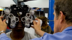 An optometrist examines a patient