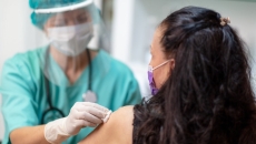 A person getting prepped to receive a vaccine