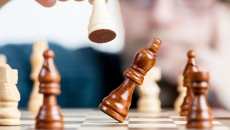 One chess piece knocking over another