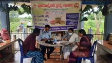 Two doctors providing in-person consultation to patients