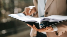 A person holding an open binder