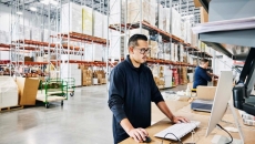 Workers in a warehouse on computers