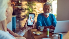 Two people consult with a doctor via telehealth