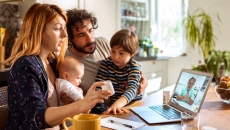A family speaking to their doctor via videochat