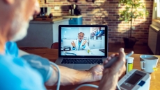 A person speaking to a clinician via computer