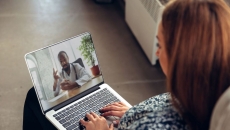 Person attending telehealth appointment on a laptop
