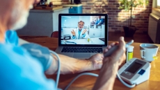 A patient communicating with health professional via videochat