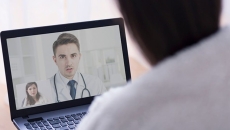 A person talking to a doctor on a computer screeen
