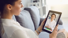 Patient attending telehealth appointment on tablet