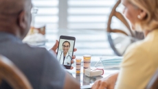 People attending telehealth appointment on smartphone