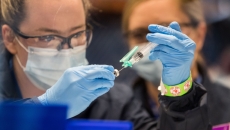 A healthcare worker prepares the COVID-19 vaccine