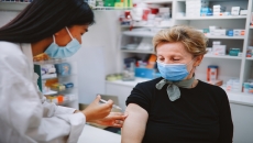 Patient in mask getting vaccine