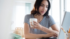 Woman on laptop engages in telehealth coaching
