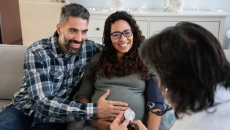 Pregnant couple talking to doctor