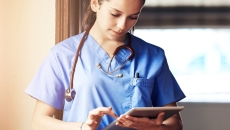 A clinician using a tablet