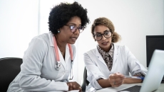 Doctors using a laptop to join a digital conference