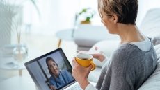 A patient at home in a teleconsult with a doctor