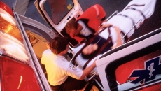 An emergency patient being taken into an ambulance