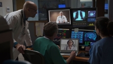 Doctors in a mixed virtual and in-person case conference