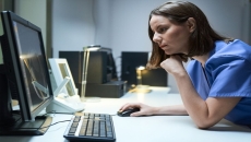 A medical professional looking at a computer screen