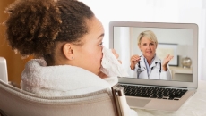 A sick patient in a video consultation with a doctor
