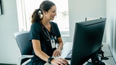 A clinician using a desktop computer