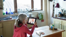 A person having a consultation with a medical professional on a tablet.
