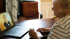 A woman speaking to her doctor via telehealth