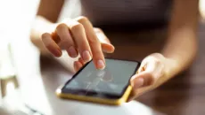 hands typing on a smartphone