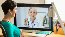 Person watching doctor on computer screen