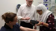Healthcare workers using a medical scanner with patient