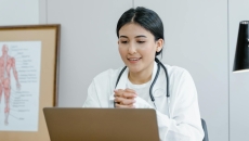 A doctor using a laptop