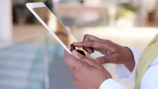 Hands holding a tablet