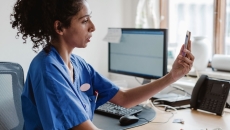 A nurse taking a video call from a smartphone