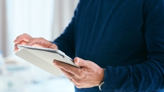 Patient looks at medical records on a tablet