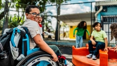 Student in a wheelchair on a playground