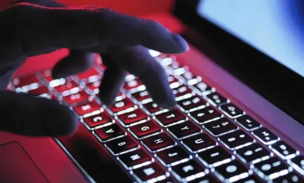 Hand on backlit keyboard