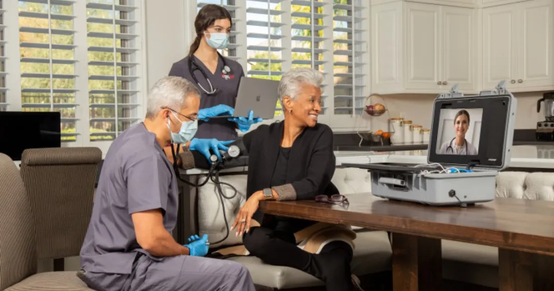 A home health visit with a screen on a table